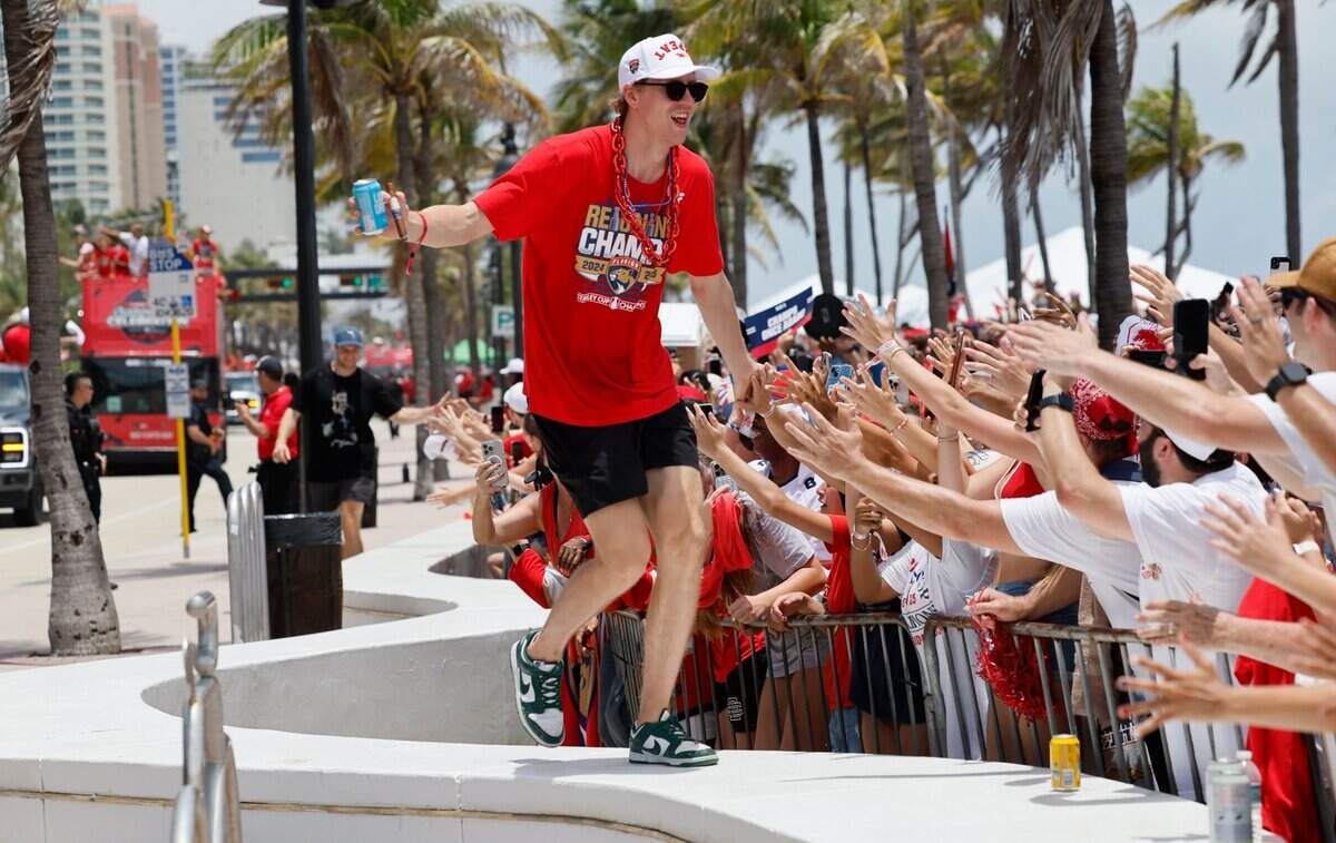 Florida Panthers defenseman Niko Mikkola interacts with a fan during the Florida Panthers Stanley Cup victory parade and rally at the beach along A1A in Fort. Lauderdale, Florida on Sunday, June 22, 2025.