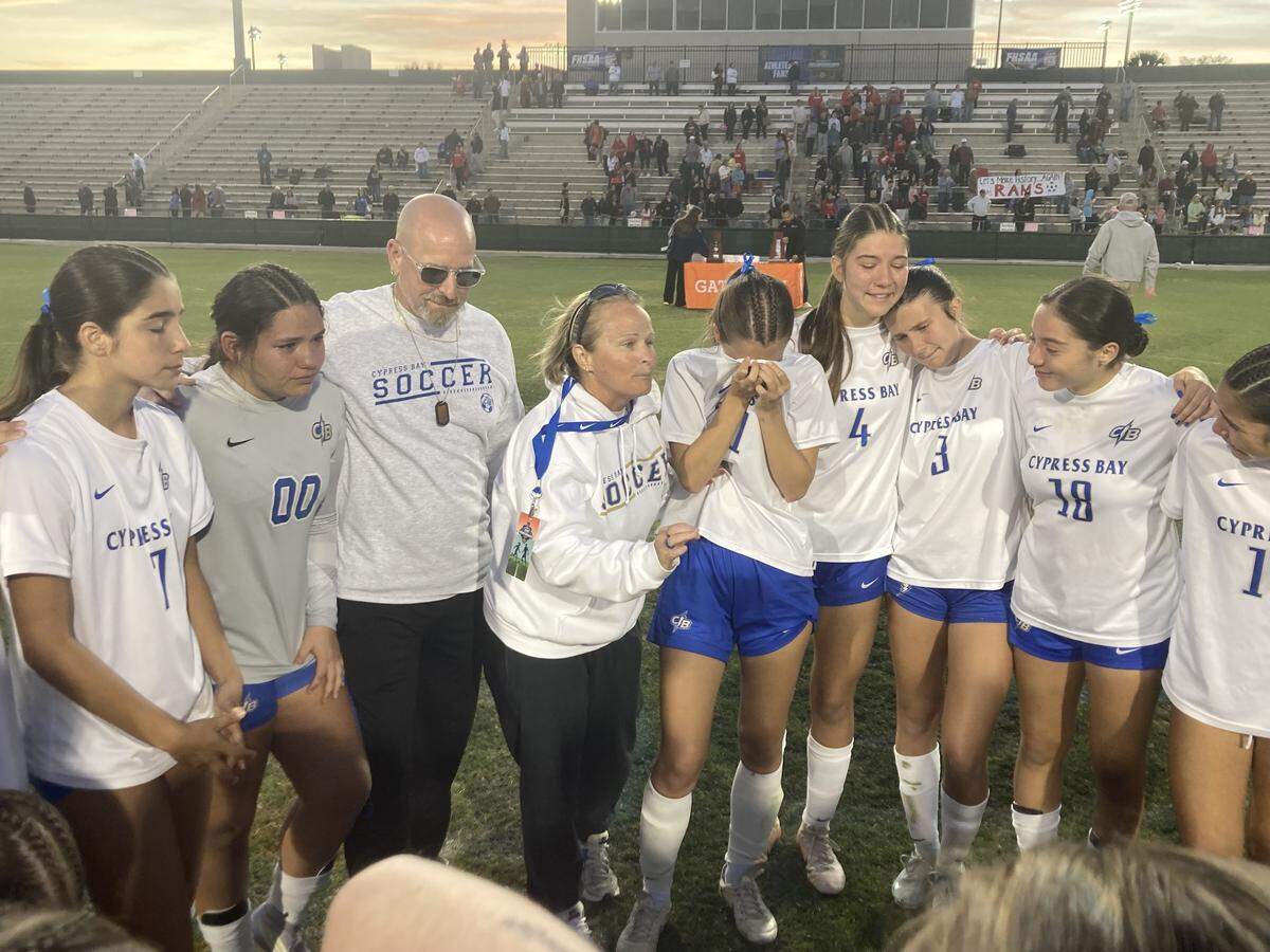 Cypress Bay girls soccer coach Kate Dwyer speaks to her players after losing the Class 7A state final to Lake Mary in a penalty kick shootout on Wednesday at Spec Martin Stadium in DeLand, Fla.