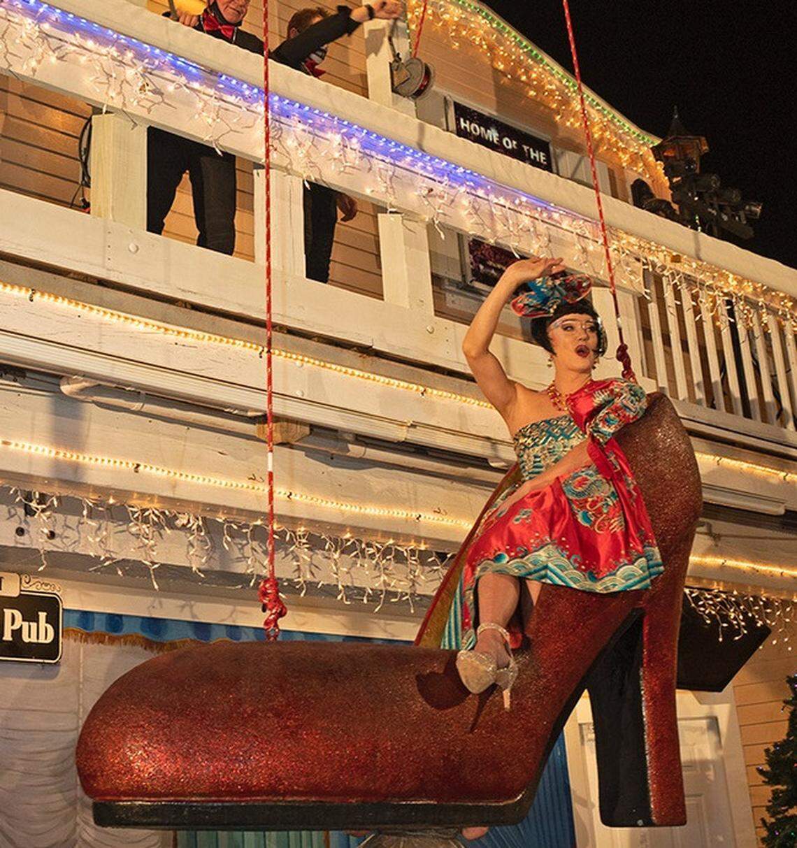 Female impersonator Gary Marion, known as “Sushi,” descends in a large replica of a women’s high heel shoe in the back courtyard of a Key West, Fla., entertainment and hotel complex Thursday, Dec. 31, 2020, to celebrate the beginning of 2021. Normally held on Duval Street at midnight, the New Year’s Eve Shoe Drop was moved behind Key West’s Bourbon St. Pub and occurred several hours early to comply with a mandatory 10 p.m. curfew that Key West city officials ordered to reduce potential coronavirus spread. FOR EDITORIAL USE ONLY (Rob O’Neal/Florida Keys News Bureau/HO)