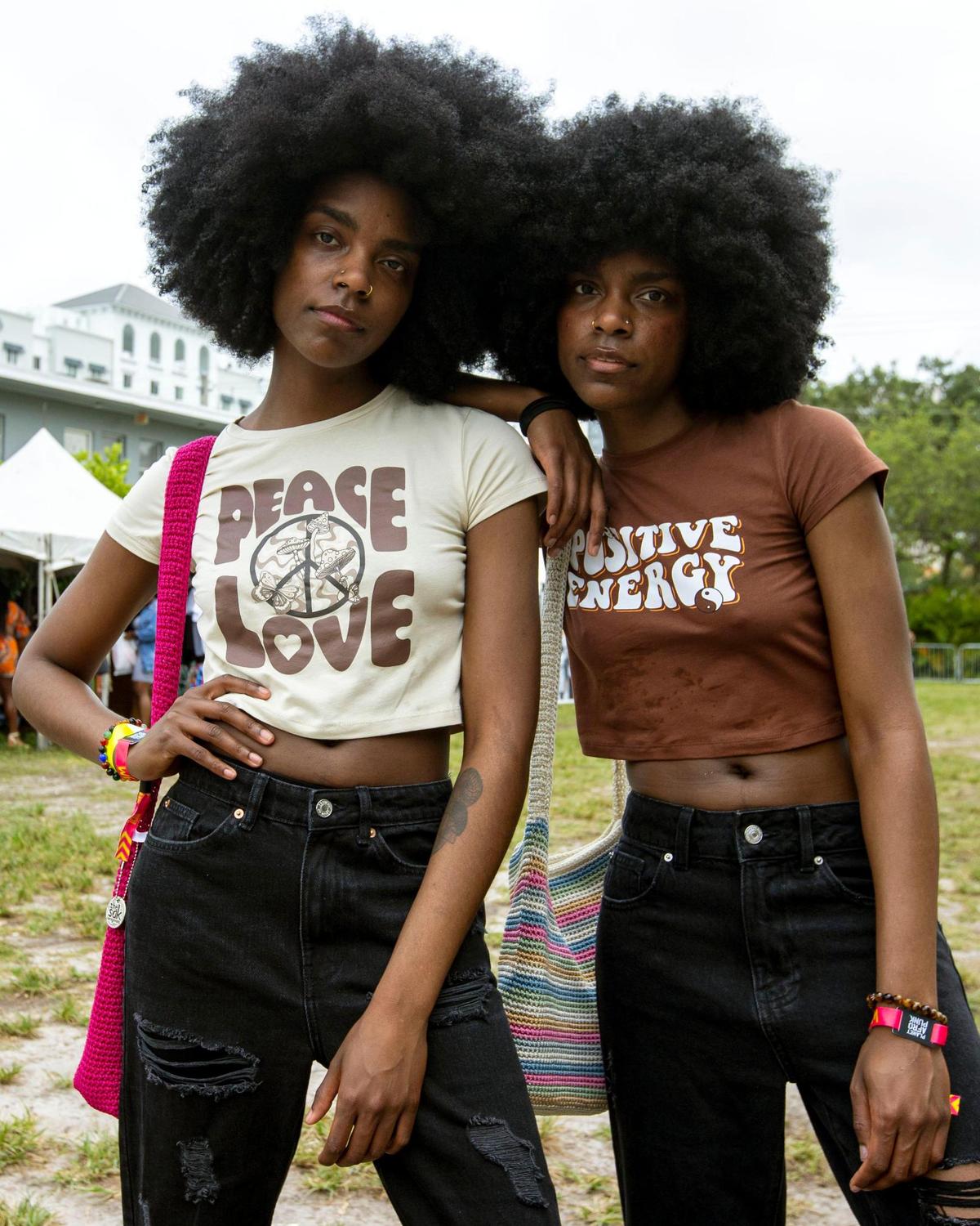 Brooklyn residents and twin sisters Delcia Johnson, left, and Alia Johnson, 30, show their outfits during AFROPUNK music festival at The Urban in the Historic Overtown neighborhood of Miami, Florida, on Saturday, May 21, 2022. They were raised in South Florida’s West Park and traveled back south just for AFROPUNK.