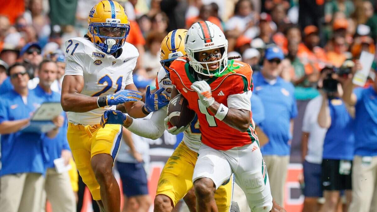 Miami Hurricanes wide receiver Malachi Toney (1) evades defenders to score against the Pittsburgh Panthers during the first half at Hard Rock Stadium in Miami Gardens, Florida, on Saturday, October 24, 2026.