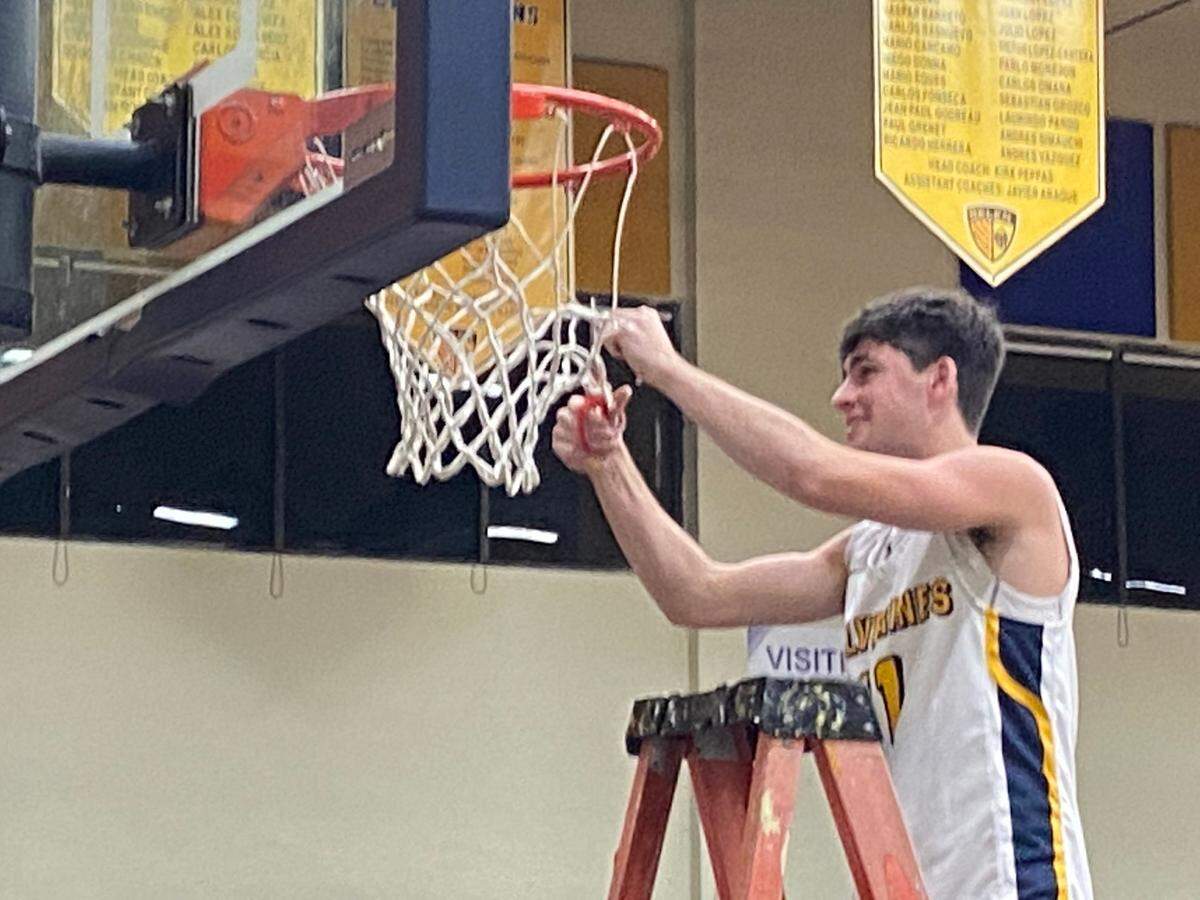 Belen guard E.J. Gross and his teammates cut down the nets at their home court on Friday night after the Wolverines clinched their first ever trip to the state final four in basketball.
