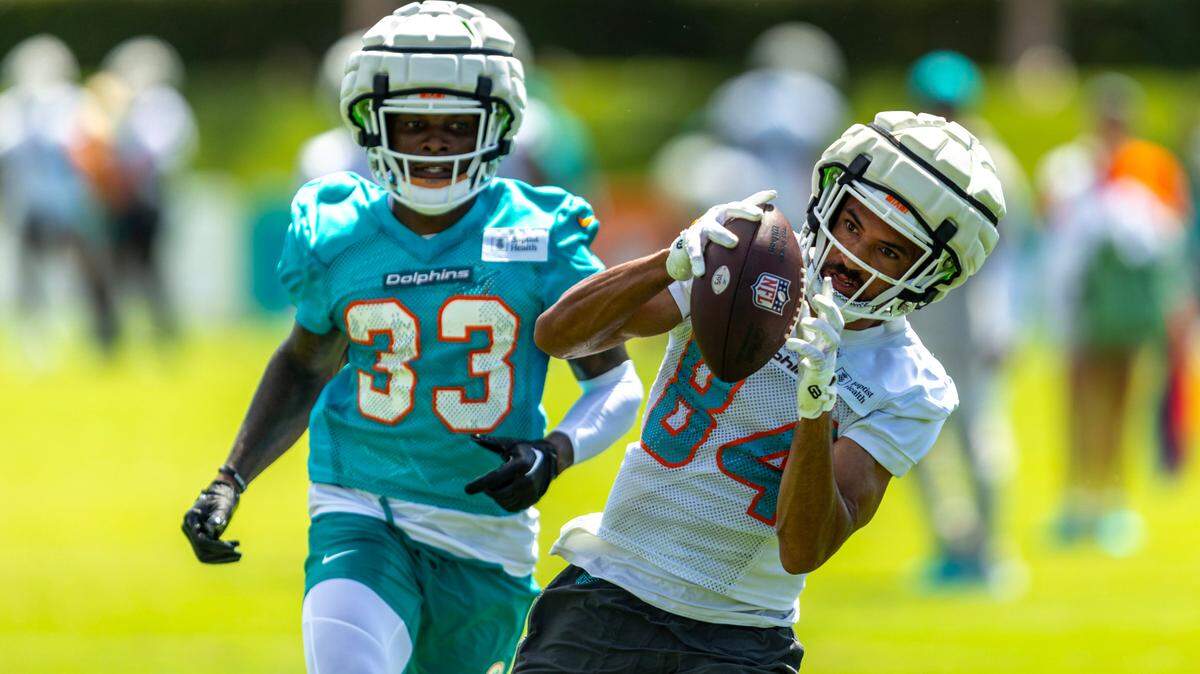 Miami Dolphins wide receiver Anthony Schwartz (84) makes a catch while defended by cornerback Siren Neal (33) during training camp at Baptist Health Training Complex on Friday, July 26, 2024, in Miami Gardens, Fla.