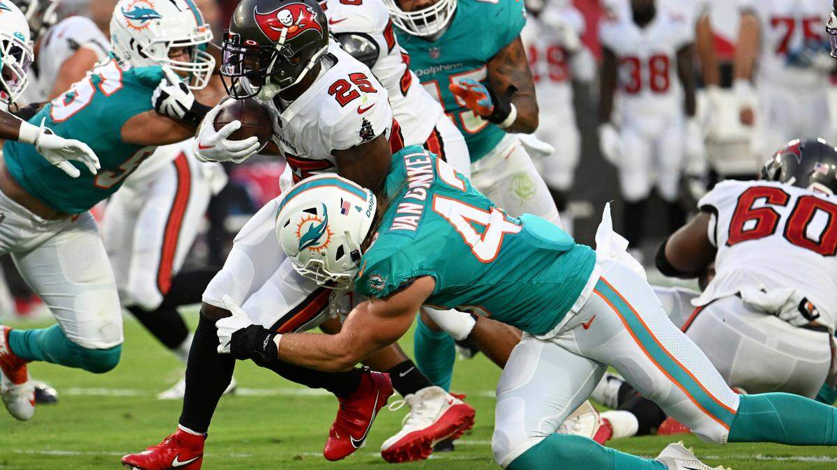 Miami Dolphins linebacker Andrew Van Ginkel (43) stops Tampa Bay Buccaneers running back Giovani Bernard (25) during the first half of an NFL preseason football game Saturday, Aug. 13, 2022, in Tampa, Fla. (AP Photo/Jason Behnken)