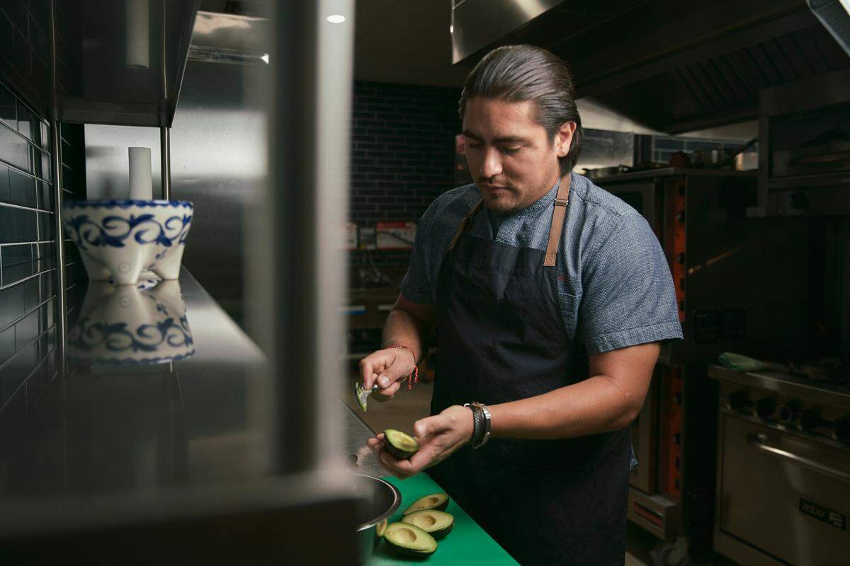 Chef Omar Montero makes guacamole at La Santa Taqueria.