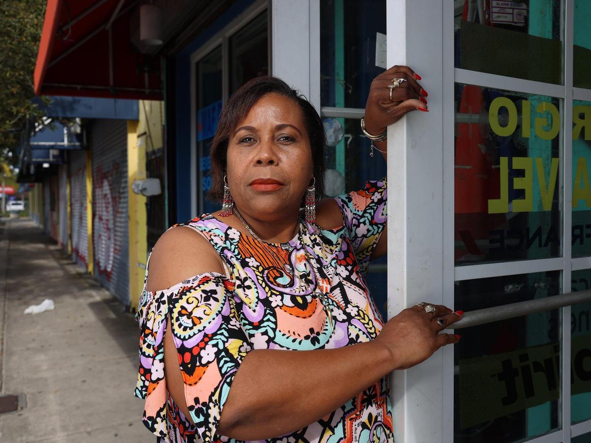 Magalie Joseph stands at the door of Sonny Sounds, her family’s longtime business in Little Haiti. She fears the business could be forced out because the building it has long occupied was sold to developers in a foreclosure auction in December of longtime landlord Mallory Kauderer’s extensive Little Haiti holdings.