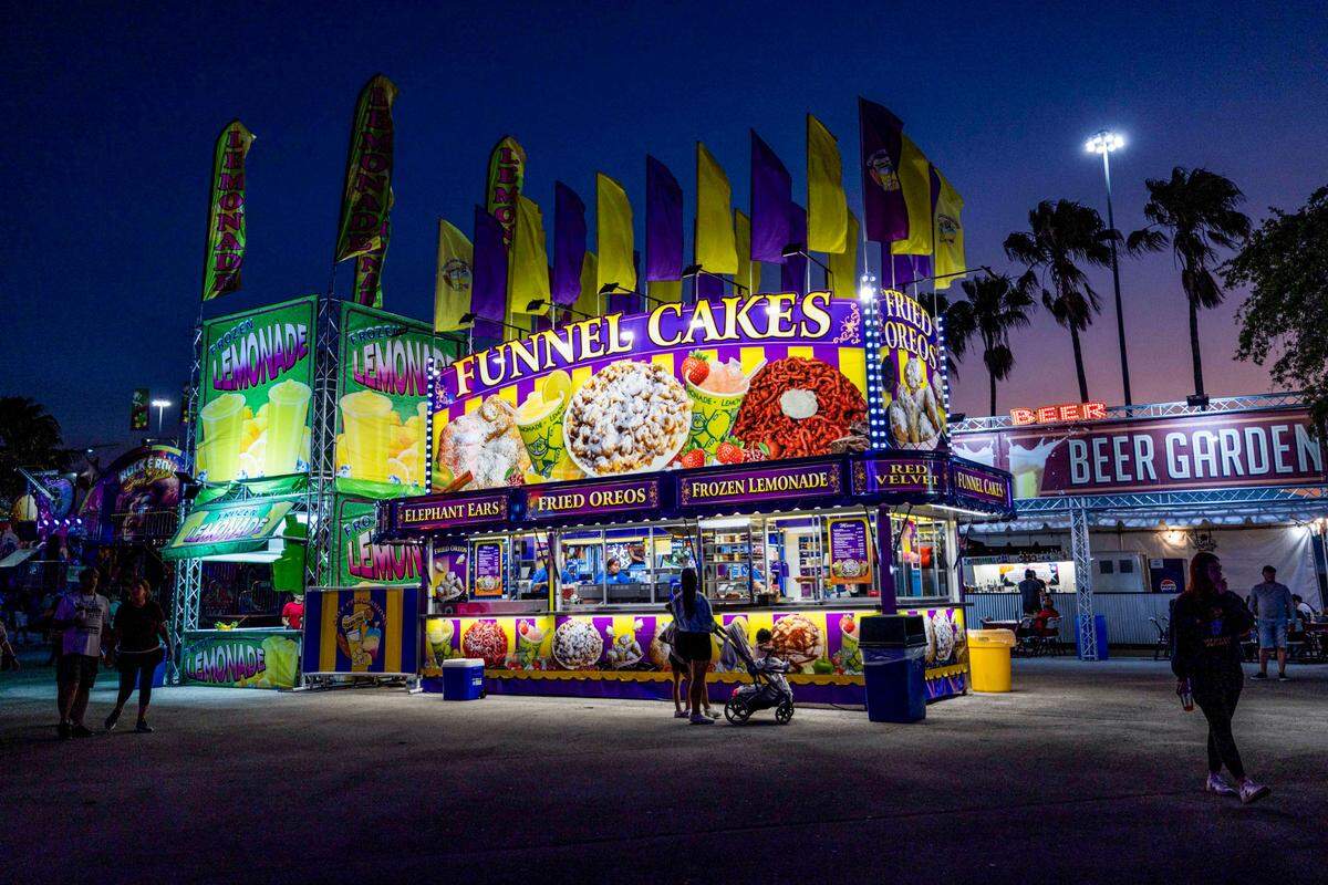 Fairgoers order funnel cakes at the Miami-Dade County Fair & Exposition