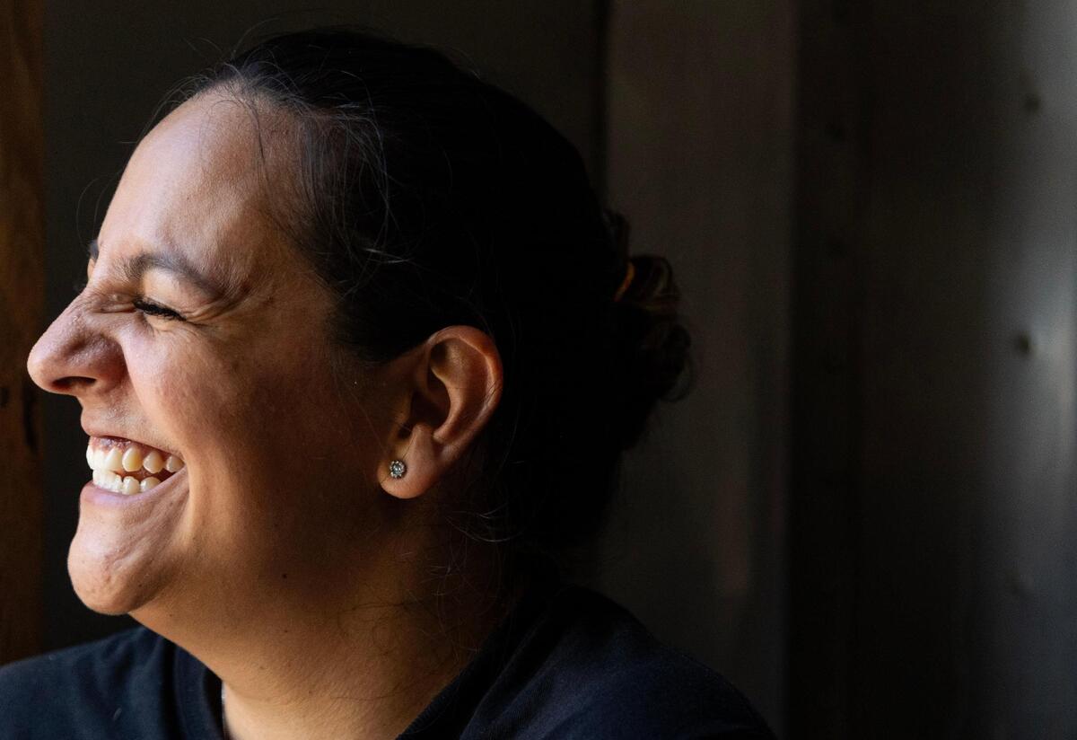 Martha Frassica-Rivera laughs while talking to Amanda Mazorra, Everglades Outpost general manager, and her brother, Alejandro, on Aug. 7, 2023. When asked about why she continues her work at the outpost, Martha recalls her love for animals throughout her life. As a kid, she would bring home birds with broken wings. “It was serendipity,” she said. “It was meant to be. It was what was in my life path.”