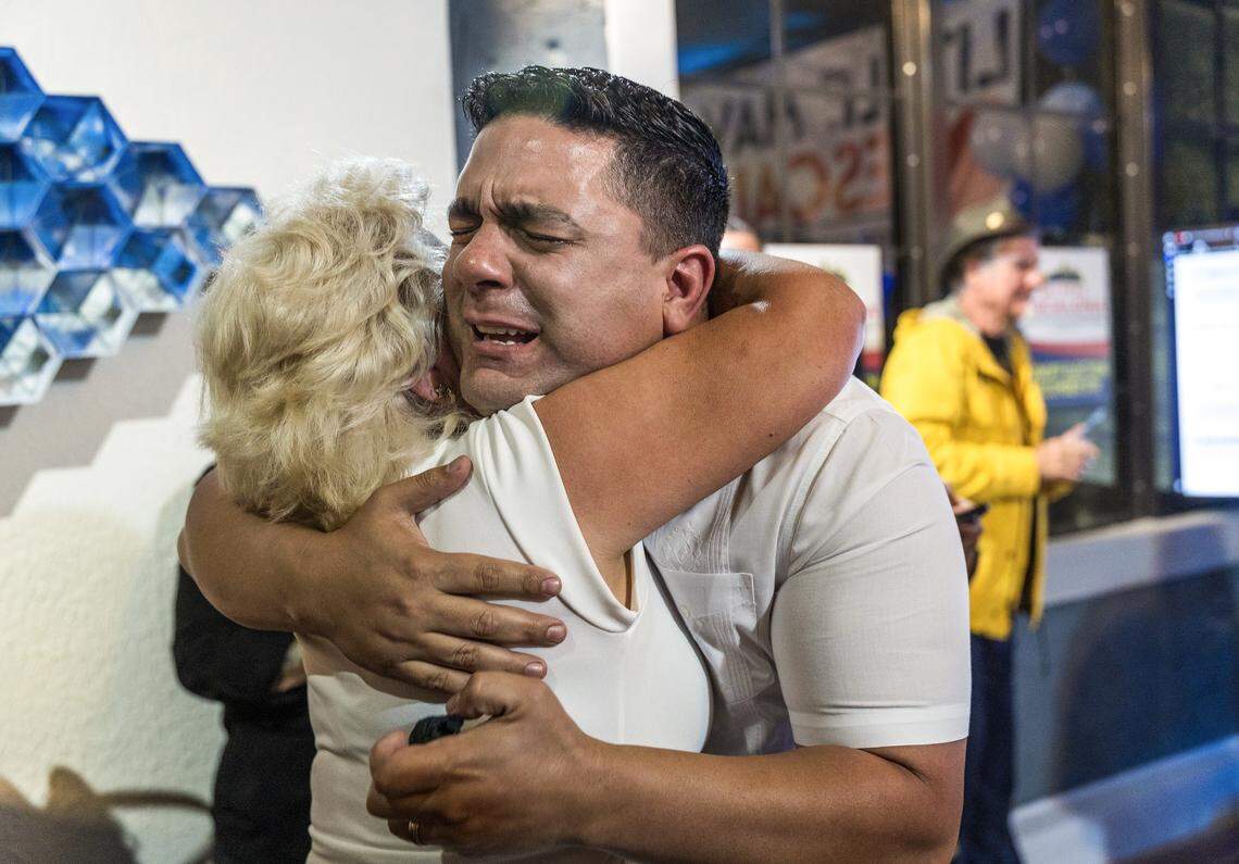 Mayra Guerra hugs her son Rolando Escalona after he defeated Frank Carollo during a runoff election on Tuesday, Dec. 9, 2025. 