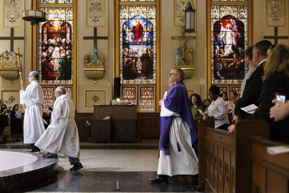 Fr. Orlando Portalatin, a Jesuit priest, center, walks up to the altar during Ash Wednesday mass on Wednesday, Feb. 18, 2026, at Gesu Catholic Church in downtown Miami.  The mass was fully packed with standing room only at the back of the church. 