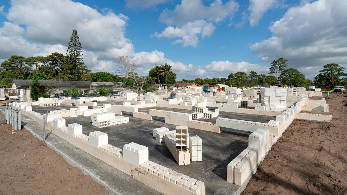 The first stage of construction of a first-of-its kind apartment building in Palm Beach County. It was built with blocks made of recycled glass, plastic and other materials that fit together like Lego pieces. A Miami company that developed the systems says it can lead to cheaper, greener buildings.