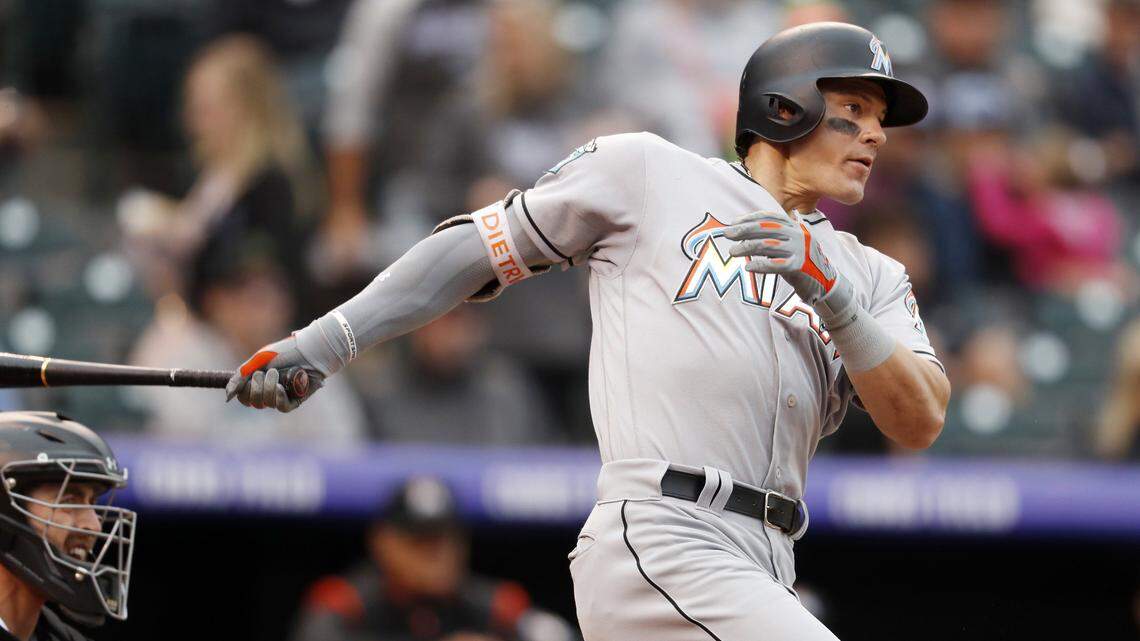 Miami Marlins' Derek Dietrich follows the flight of his single off Colorado Rockies starting pitcher German Marquez in the third inning of a baseball game Sunday, June 24, 2018, in Denver. (AP Photo/David Zalubowski)