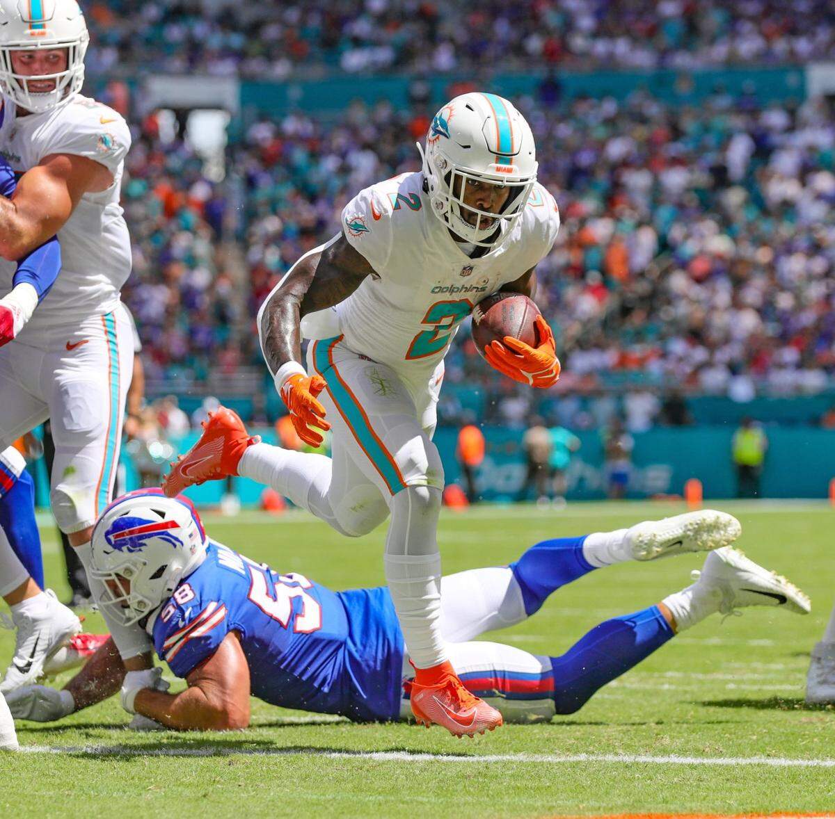 Miami Dolphins running back Chase Edmonds (2) scores as Buffalo Bills linebacker Matt Milano (58) fails to make the tackle in the second quarter at Hard Rock Stadium in Miami Gardens on Sunday, September 25, 2022.