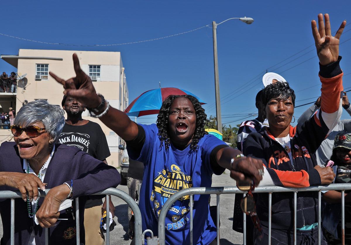 Miami Northwestern alumna Patricia Lawrence, center, cannot contain herself as Northwestern Bulls march up Northwest 54th Street during the MLK Day Parade in Liberty City. The annual parade features marching bands, food vendors, music, and much more as Miami’s Liberty City neighborhood celebrates the legacy of Martin Luther King Jr.