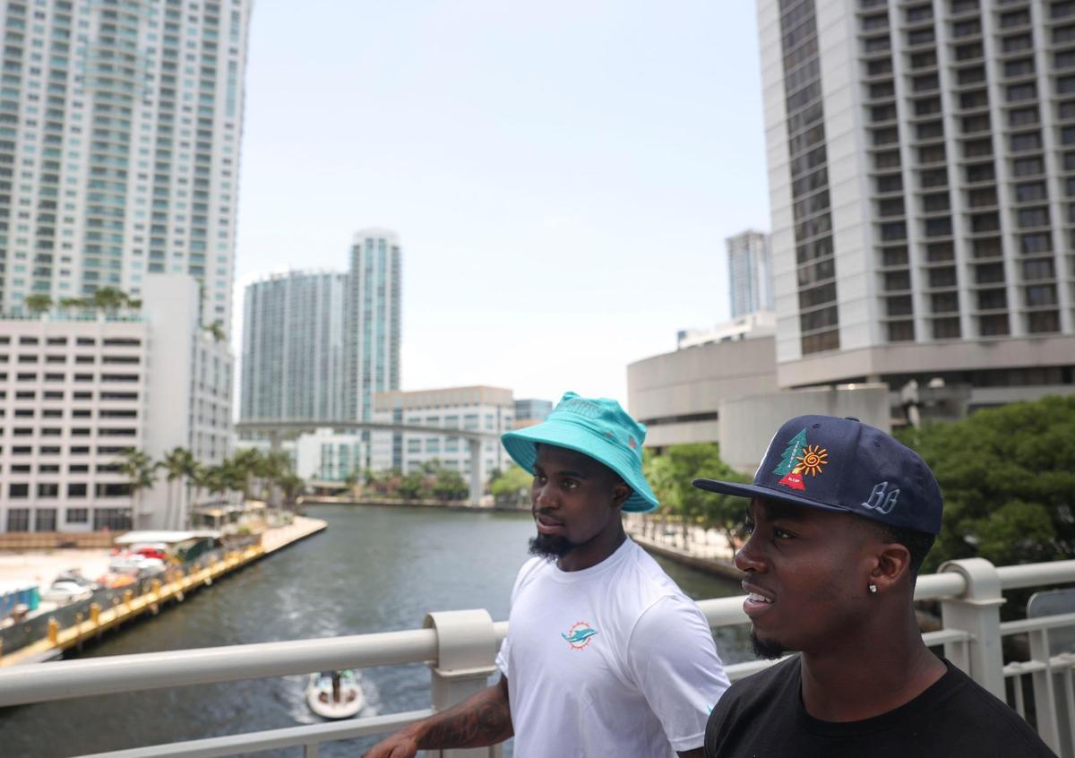 ZaQuandre White, left, running back in the Miami Dolphins rookie class, and Kader Kohou, defensive back, participate in a historic walking tour of Downtown Miami with local community groups on Wednesday, June 15, 2022, beginning with tour leaders at the History Miami Museum.