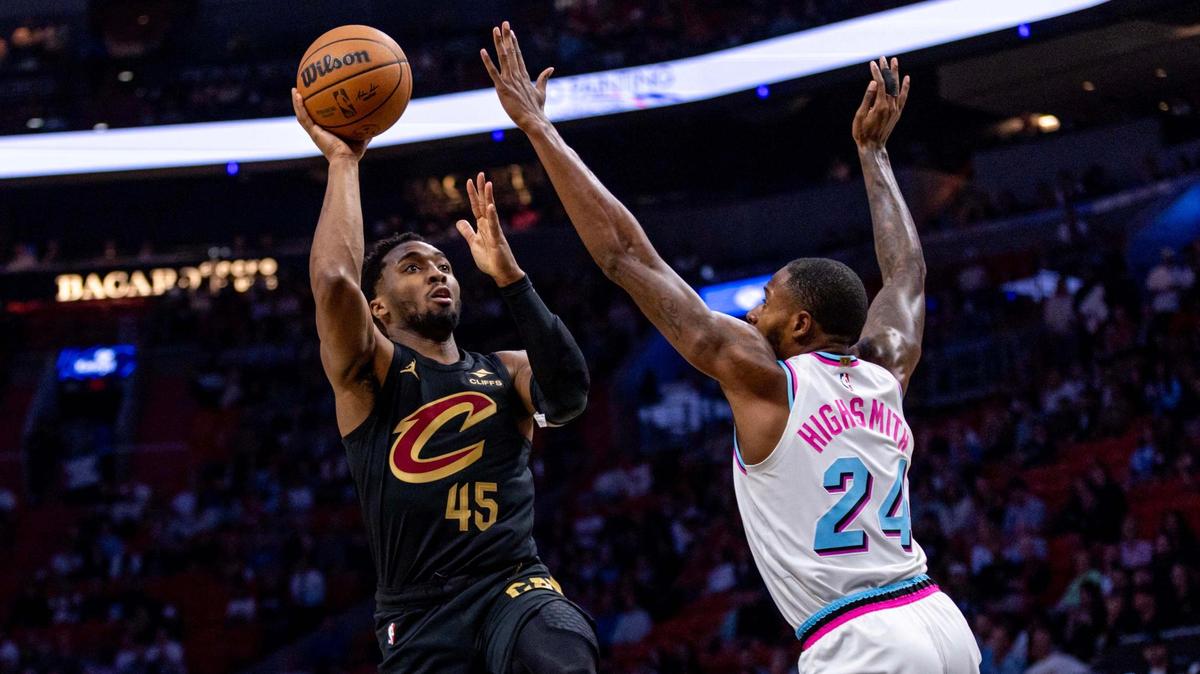 Cleveland Cavaliers guard Donovan Mitchell (45) shoots a jumper over Miami Heat forward Haywood Highsmith (24) during the first half of an NBA game at Kaseya Center on January 29, 2025, in Miami.
