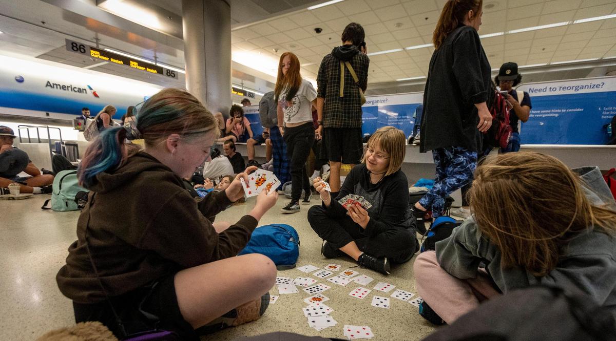 Miami, Florida - June 20, 2023 - Stranded Middle School students pass away the time playing cards at MIA . A group of Middle school students from Reno, Nevada missed their connection to Costa Rica last night after their flight to Miami was diverted to Tampa due to thunderstorms.