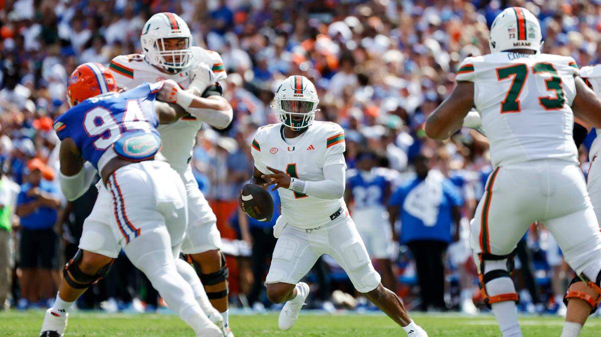Miami Hurricanes quarterback Cam Ward (1) looks to pass during the first half of an NCAA college football game against the Florida Gators at Ben Hill Griffin Stadium in Gainesville, Florida, on Saturday, August 31, 2024.