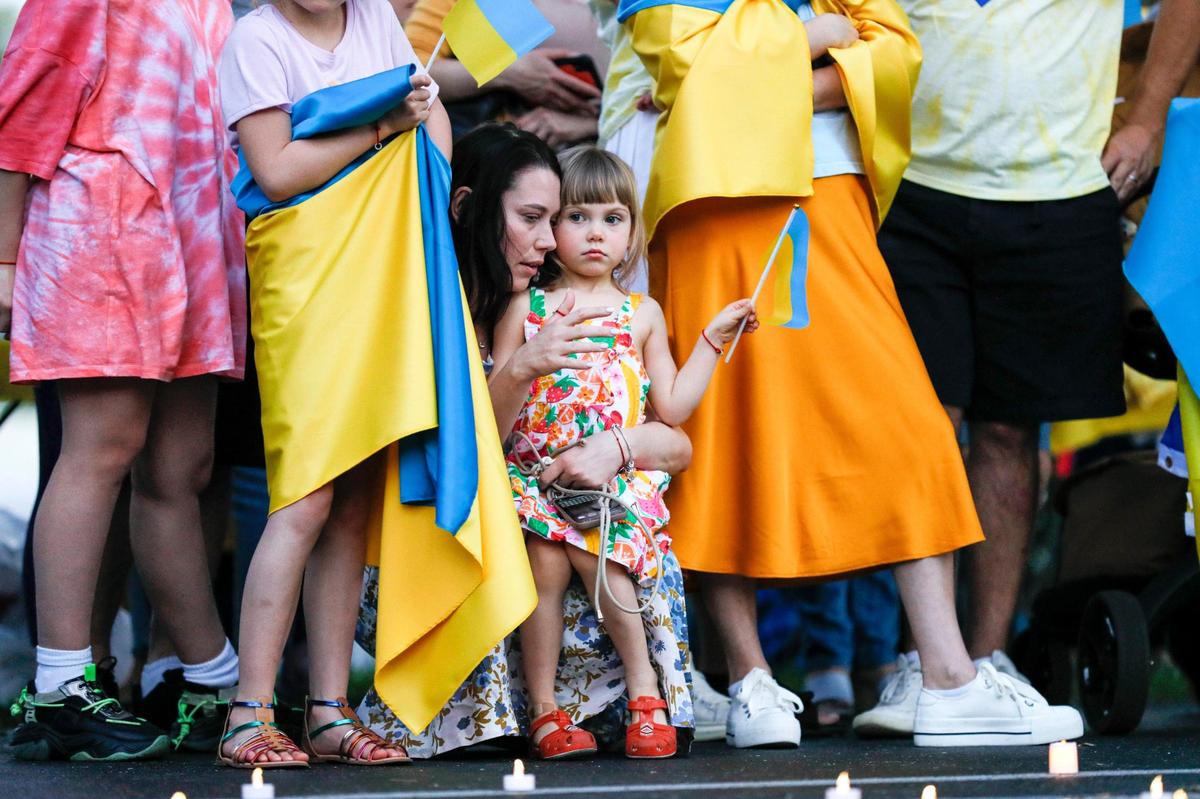 Anastasiia Sibiriakova, originally from the city of Bucha in Ukraine, talks to her 4-year-old daughter Olivia during a rally to support Ukrainians affected by the Russian invasion of Ukraine at St Nicholas Ukrainian Orthodox Church in Cooper City, Florida.