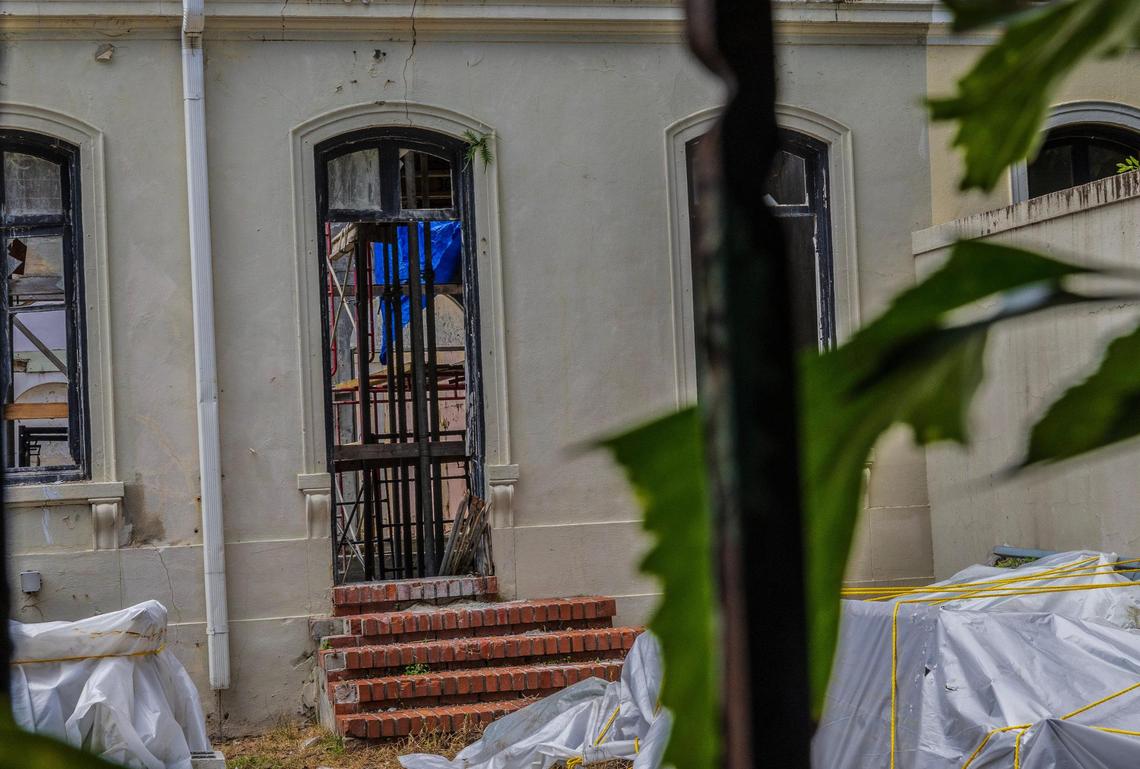 The ruined interior of a landmark 1925 house in Coral Gables’ historic French City Village that is in danger of collapsing after years of neglect by its owners can be seen through its missing windows and front door.