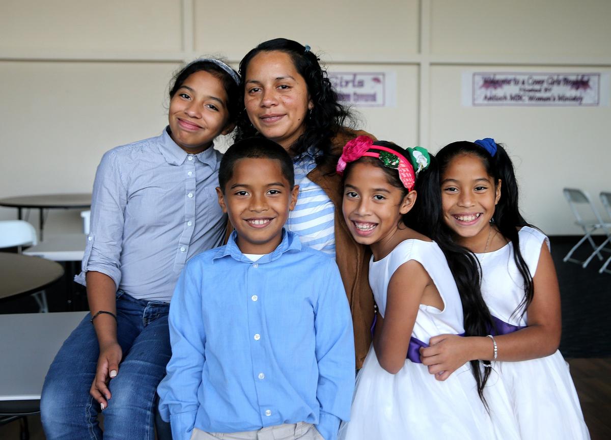 Honduran Wendlin Girón with her children, from left, 12-year-old Roxana Banegas, 8-year-old Uziel, and 10-year-old twins Suamy Yulieth and Suamy Lizbeth on Friday, December 12, 2019 at the North Dade Community Church, where they go every Sunday for service.