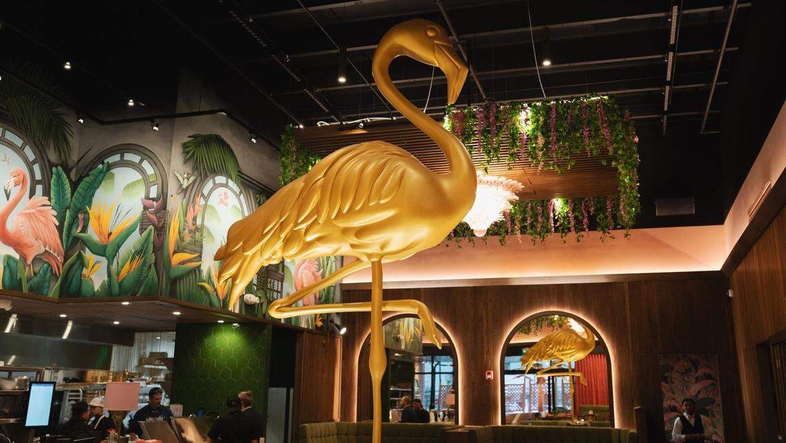 A giant gold flamingo statue is the decor focal point at Pink Steak in Palm Beach, Florida.