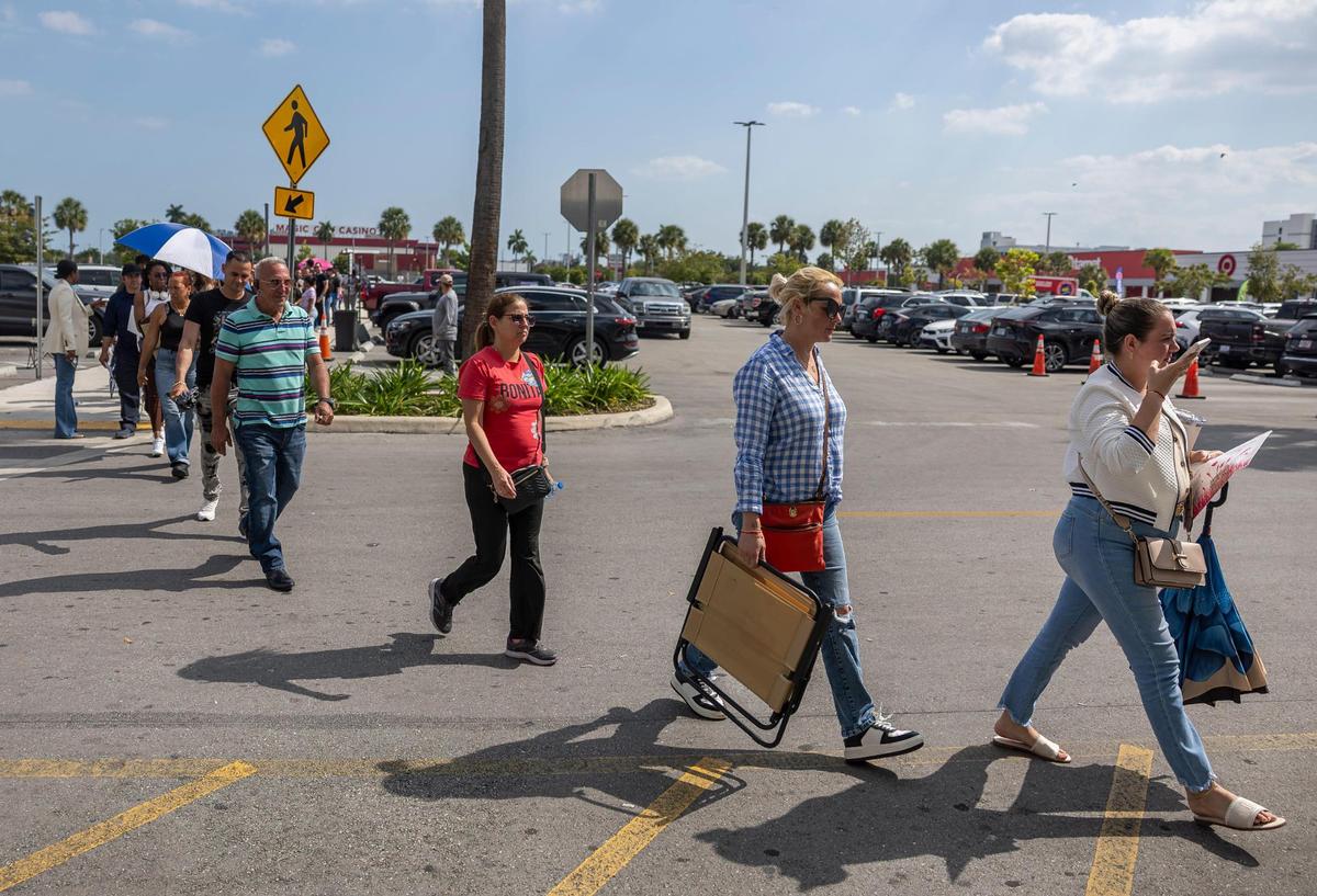 People who arrived without appointments and had been waiting in line for hours are let inside the Miami Central DMV office on Wednesday, April 16, 2025, in Miami.