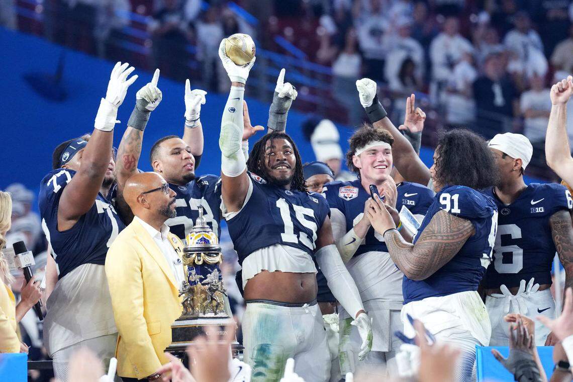 Dec 31, 2024; Glendale, AZ, USA; Penn State Nittany Lions defensive end Amin Vanover (15) reacts with the trophy after defeating the Boise State Broncos in the Fiesta Bowl at State Farm Stadium. Mandatory Credit: Joe Camporeale-Imagn Images