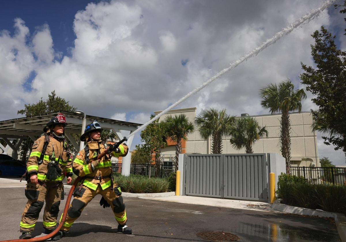Lt. Veronica Cordoba, left, supervises Jared Lago, a new crew member, in a forward lay training exercise during a shift on Thursday, April 3, 2025, at Dolphin Station 68 in Sweetwater, Florida. The forward lay allows the crew to connect directly to a fire hydrant in order to keep water flowing so they can fight fires.