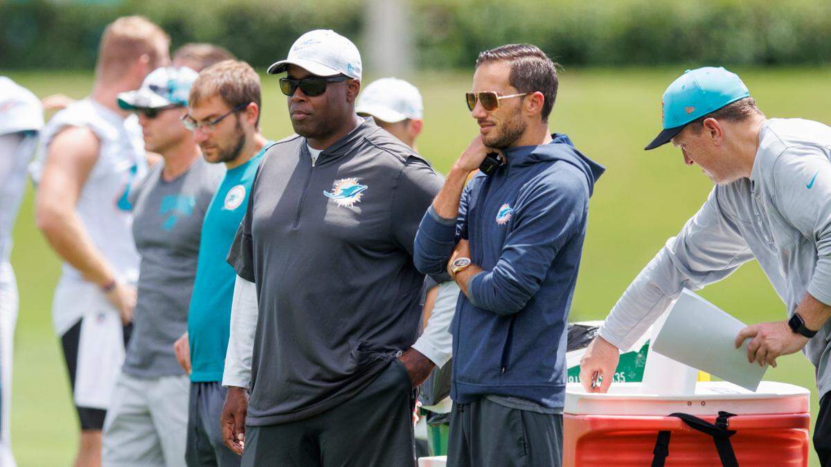 Miami Dolphins head coach Mike McDaniel and Dolphins general manager Chris Grier look from the sidelines during NFL football training camp at Baptist Health Training Complex in Hard Rock Stadium on Thursday, September 1, 2022 in Miami Gardens, Florida.
