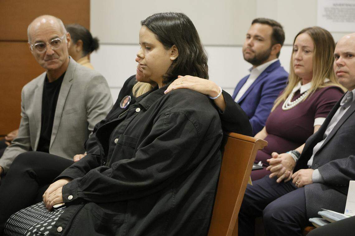 Annika Dworet embraces Sam Fuentes, center, who was injured in the 2018 shootings, after Fuentes gave her victim impact statement during the sentencing hearing for Marjory Stoneman Douglas High School shooter Nikolas Cruz at the Broward County Courthouse in Fort Lauderdale on Wednesday, Nov. 2, 2022. Dworet’s son, Nicholas, was killed, and their other son, Alexander, was injured in the 2018 shootings.