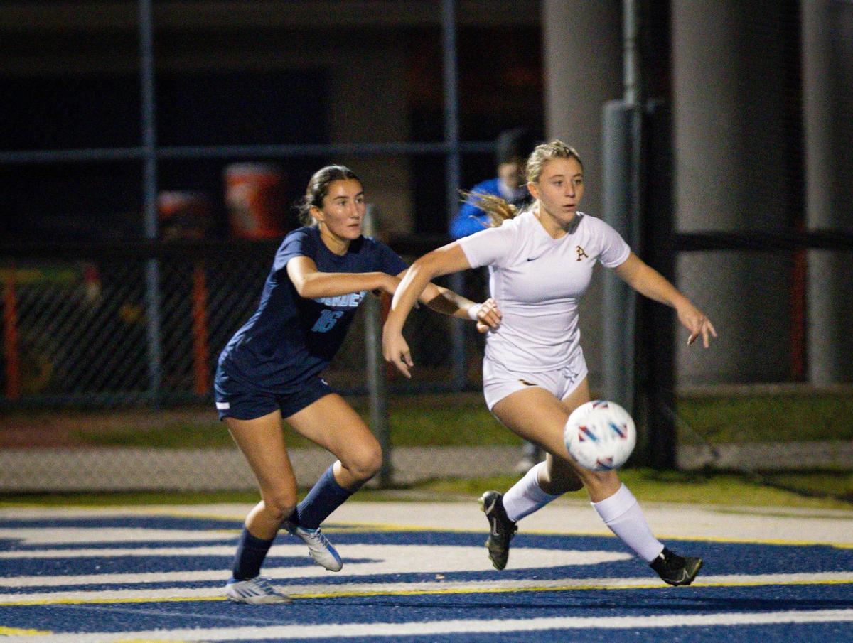St. Thomas Aquinas’ Madison Mckeon (9) attempts a shot on goal while defended by Our Lady of Lourdes’ Ariana Gonzalez (16) during the second half of the regional soccer final on Wednesday, Feb. 21, 2024, at Columbus High School in Miami.
