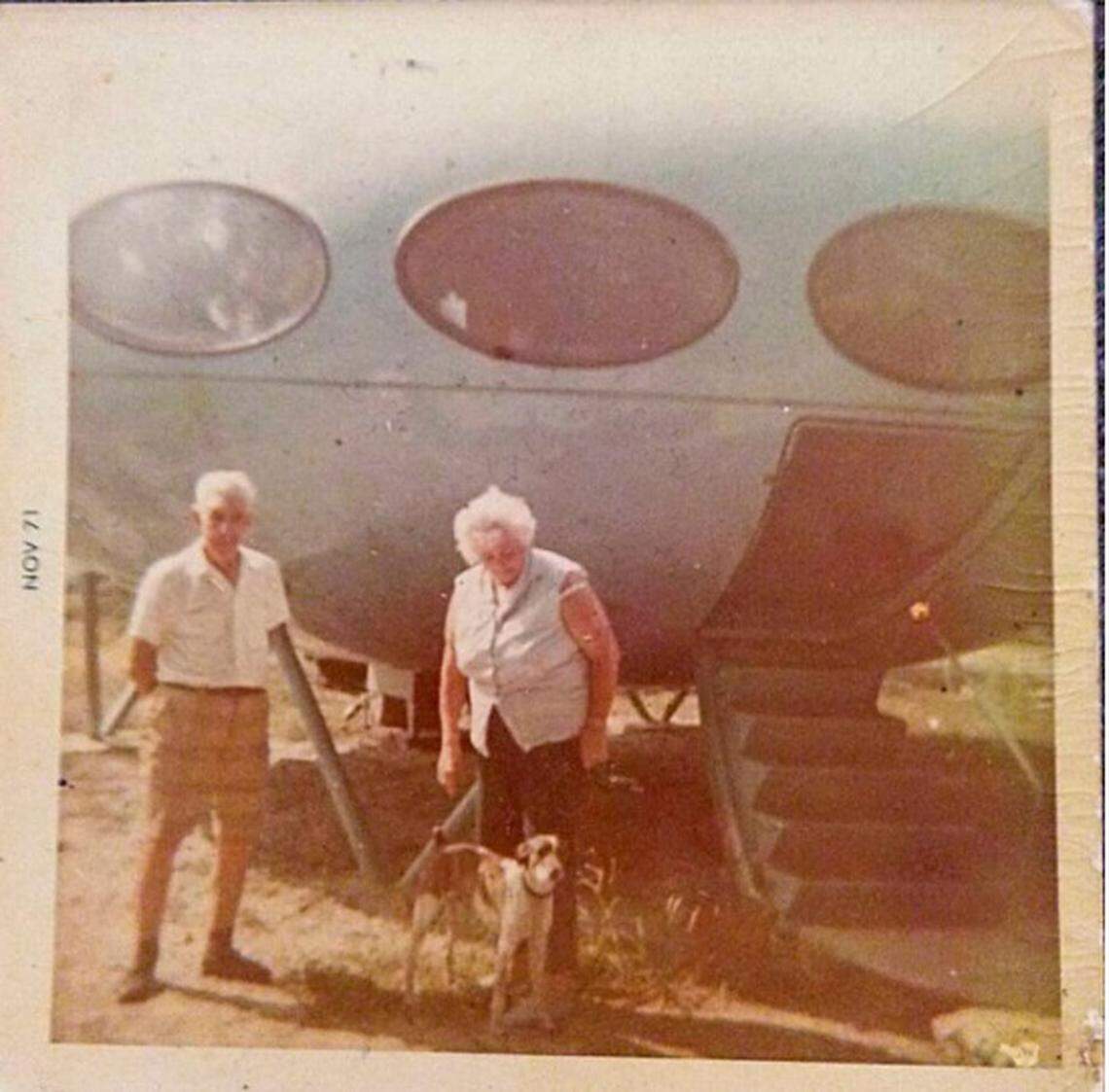 Gwendolyn Zerby stands outside her Futuro house with her dog, Spud.