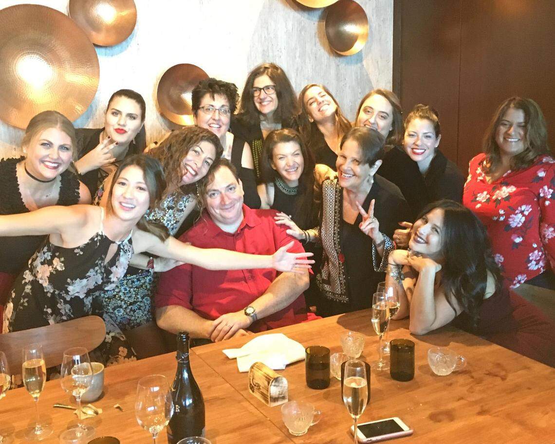 The Brustman Carrino Public Relations agency in Miami celebrated the 2016 holiday season with a group photo. Larry Carrino is seated in red. Susan Brustman is to the right making a peace sign.