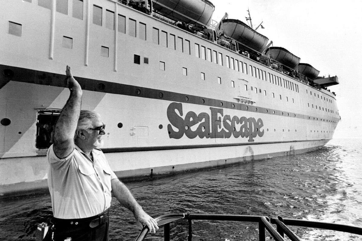 Harbor Pilot Dario Pedrajo Waves goodbye to the Sea Escape after piloting it out of Port of Miami in 1985.