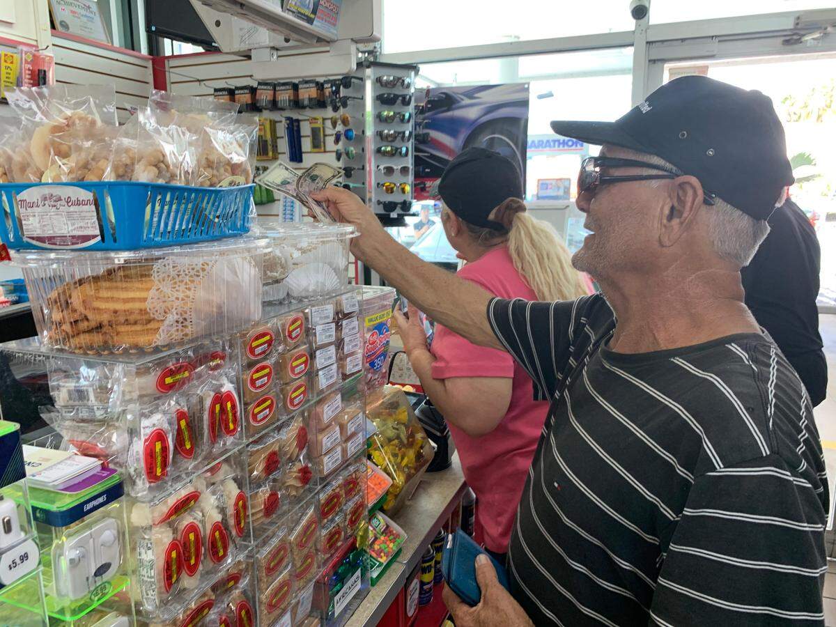 Drivers, like Desi Cuevas, went inside the Marathon gas station Wednesday to pay with cash and credit card during UniVista’s 99 cent gas celebration.