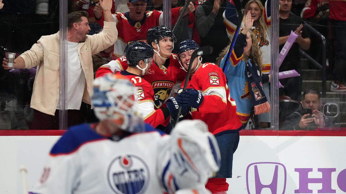 Nov 20, 2023; Sunrise, Florida, USA; Florida Panthers defenseman Niko Mikkola (77) celebrates his goal against the Edmonton Oilers with teammates on the ice during the second period at Amerant Bank Arena. Mandatory Credit: Jasen Vinlove-USA TODAY Sports