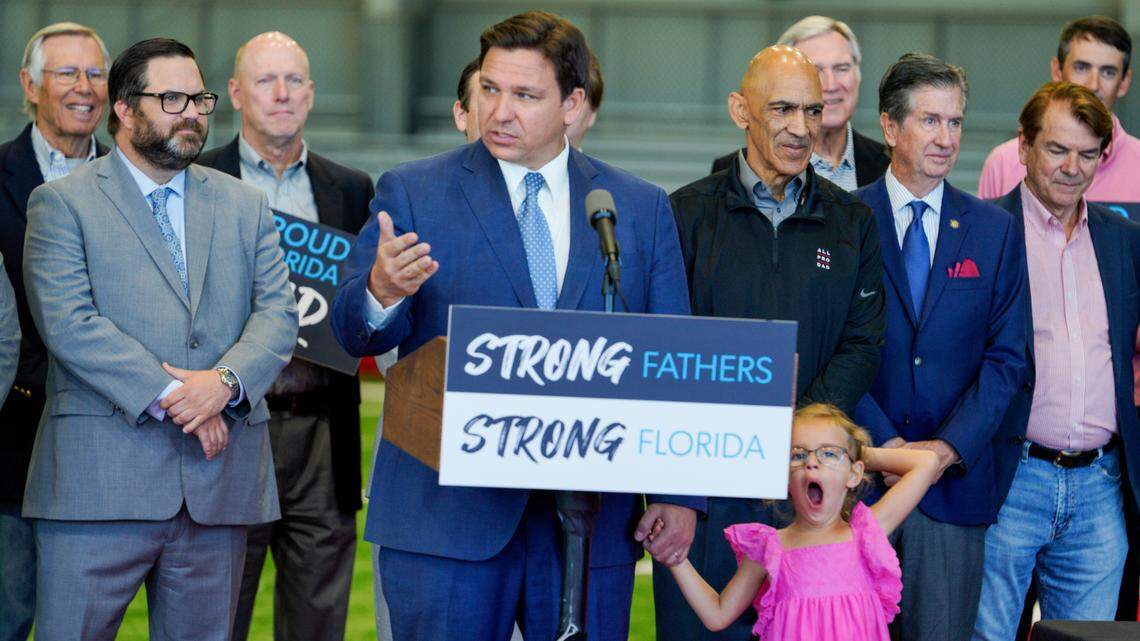 Florida Gov. Ron DeSantis holds on to his daughter, Madison, 5, during a news conference Monday, April 11, 2022, at the Tampa Bay Buccaneers’ training facility, AdventHealth Training Center, in Tampa. DeSantis signed a bill aimed at supporting fatherhood by connecting men with career services and children with mentorship, a priority for House Speaker Chris Sprowls.