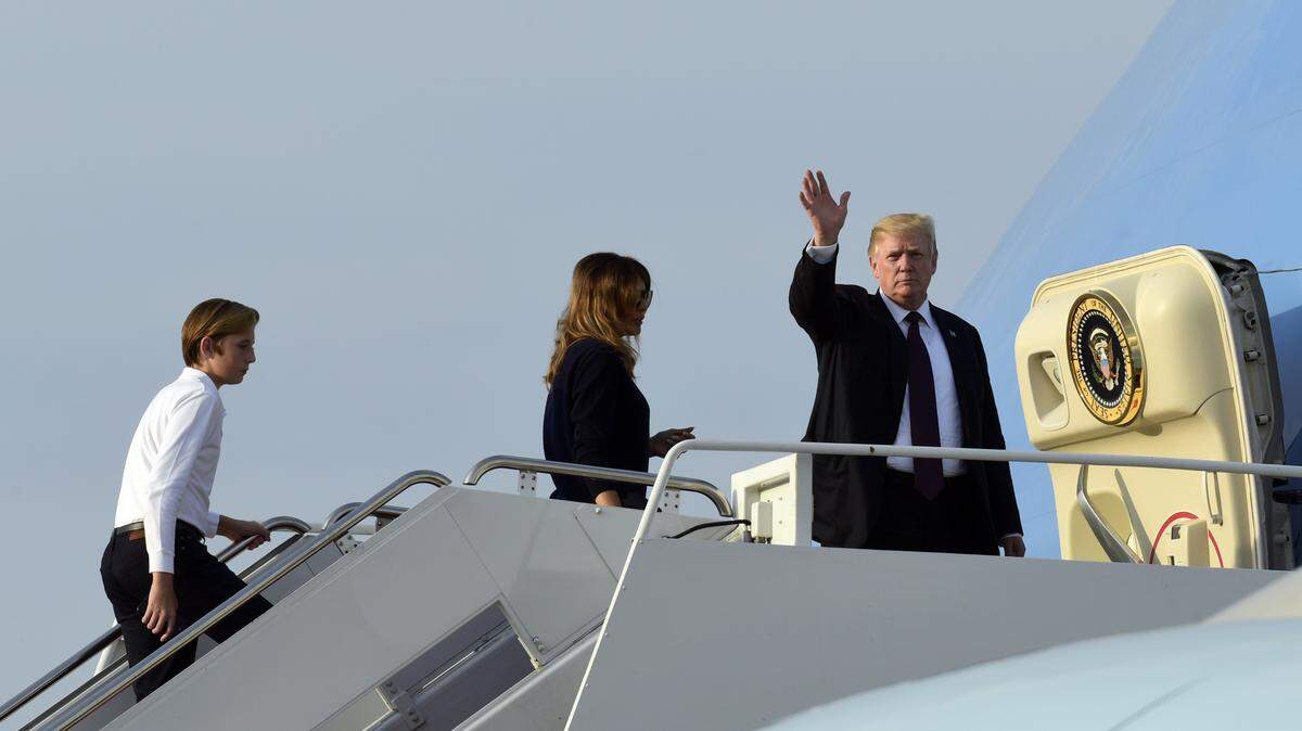 President Donald Trump, first lady Melania Trump, and their son Barron walk up the steps of Air Force One at Palm Beach International Airport in West Palm Beach, Fla., after spending a week in November at Mar-a-Lago.
