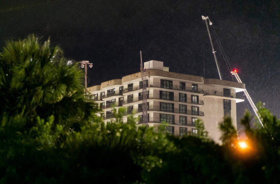 Cranes stand idle as rain falls over the partially collapsed Champlain Towers South Condo in Surfside, Florida on Thursday, July 1, 2021. Rescue operations halted over safety concerns for the remaining structure.