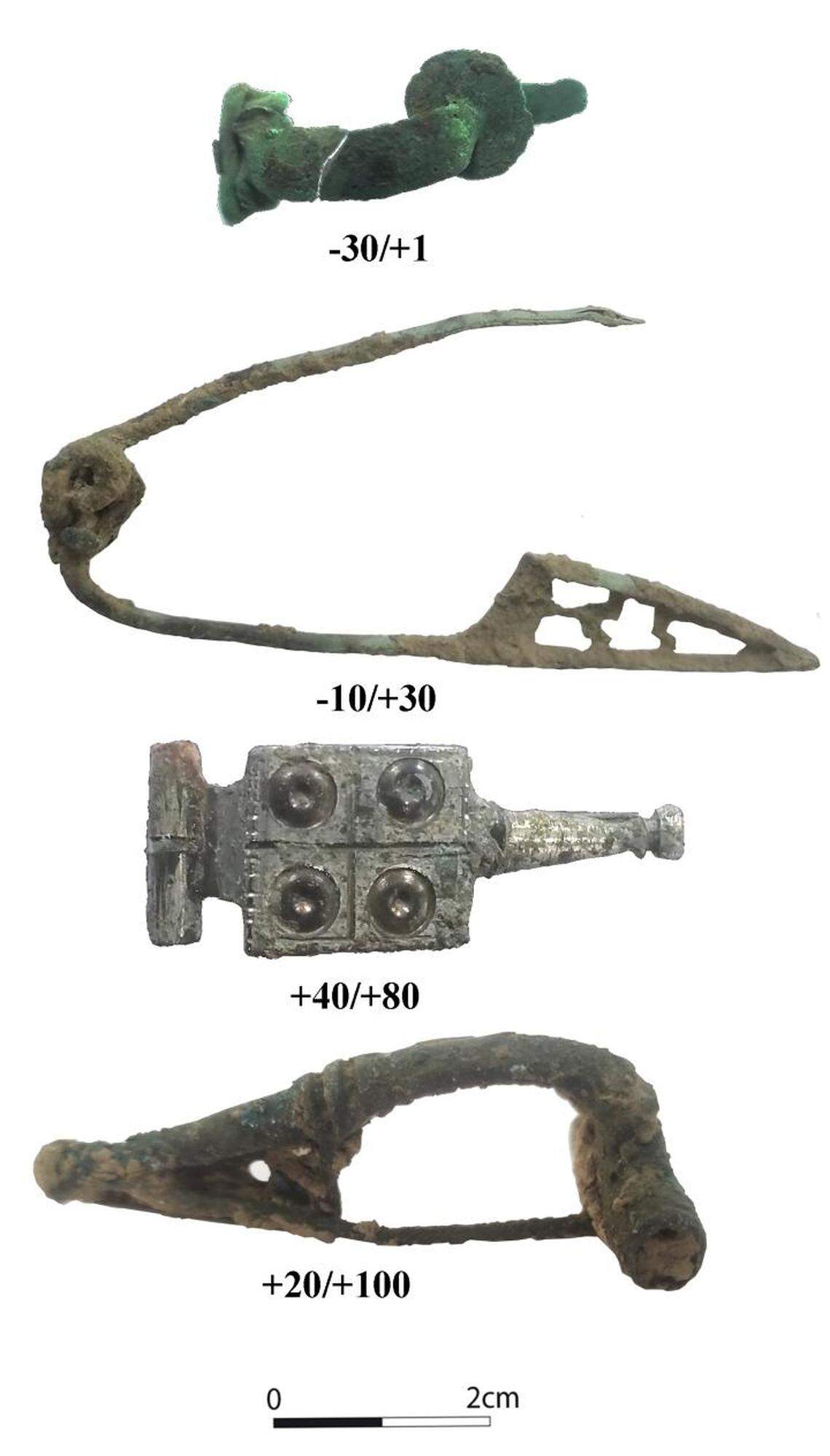 Ancient artifacts, including these four fibulae, were discovered in the limestone pit.
