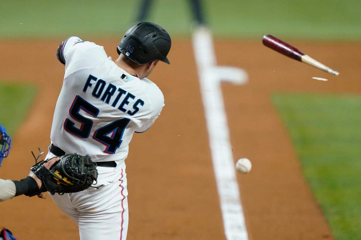 Miami Marlins’ Nick Fortes (54) breaks his bat and singles to load the bases during the third inning of a baseball game against the Chicago Cubs, Monday, Sept. 19, 2022, in Miami. (AP Photo/Lynne Sladky)