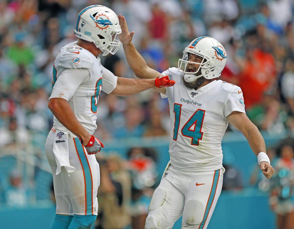 Miami Dolphins tight end Mike Gesicki (88) and quarterback Ryan Fitzpatrick (14) celebrate after a second quarter touchdown by the Dolphins as the Miami Dolphins host the New York Jets at Hard Rock Stadium in Miami Gardens on Sunday, November 3, 2019.