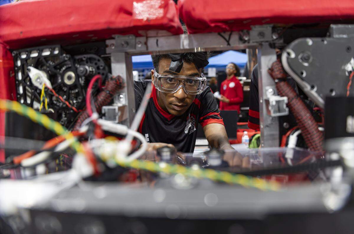 Palm Beach Central High School student Kareem Ahmed, 18, a member of the Bionic Broncos, troubleshoots his team’s robot, Bucky Barnes, as they prepare to compete in the 2026 FIRST Robotics South Florida Regional Competition at the University of Miami’s Watsco Center on Friday, April 10, 2026, in Coral Gables, Fla. Participants from local school districts, surrounding states, and international teams are competing for an opportunity to earn a spot at the 2026 FIRST World Championship.