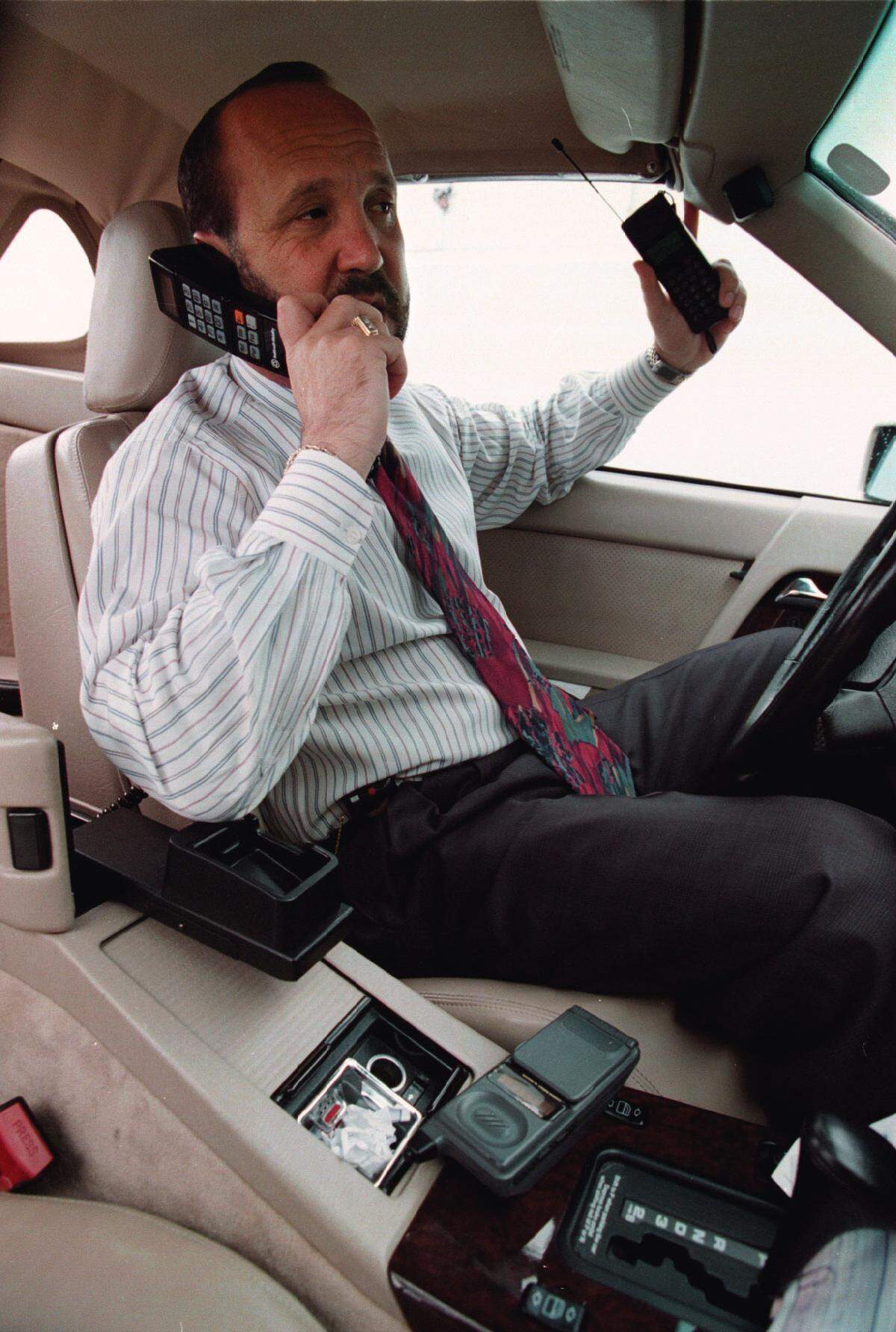 Lobbyist Ron Book, equipped with three different cellular phones able to keep him in constant communication during drive time, is pictured Feb. 18, 1994.