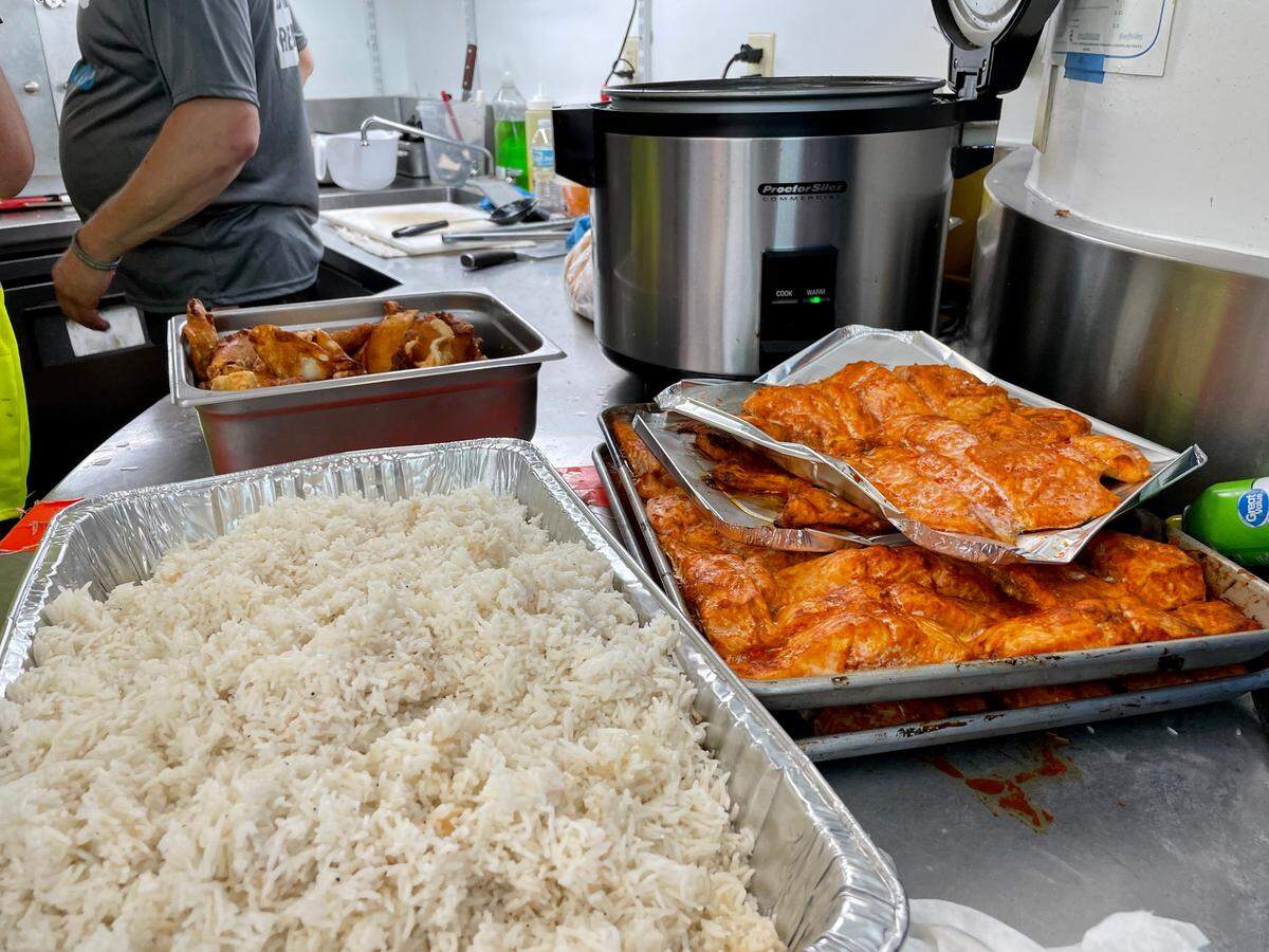 Oven-baked salmon and white rice are part of the kosher meals being cooked at the Surfside Community Center for families and first responders of the Surfside condo collapse.