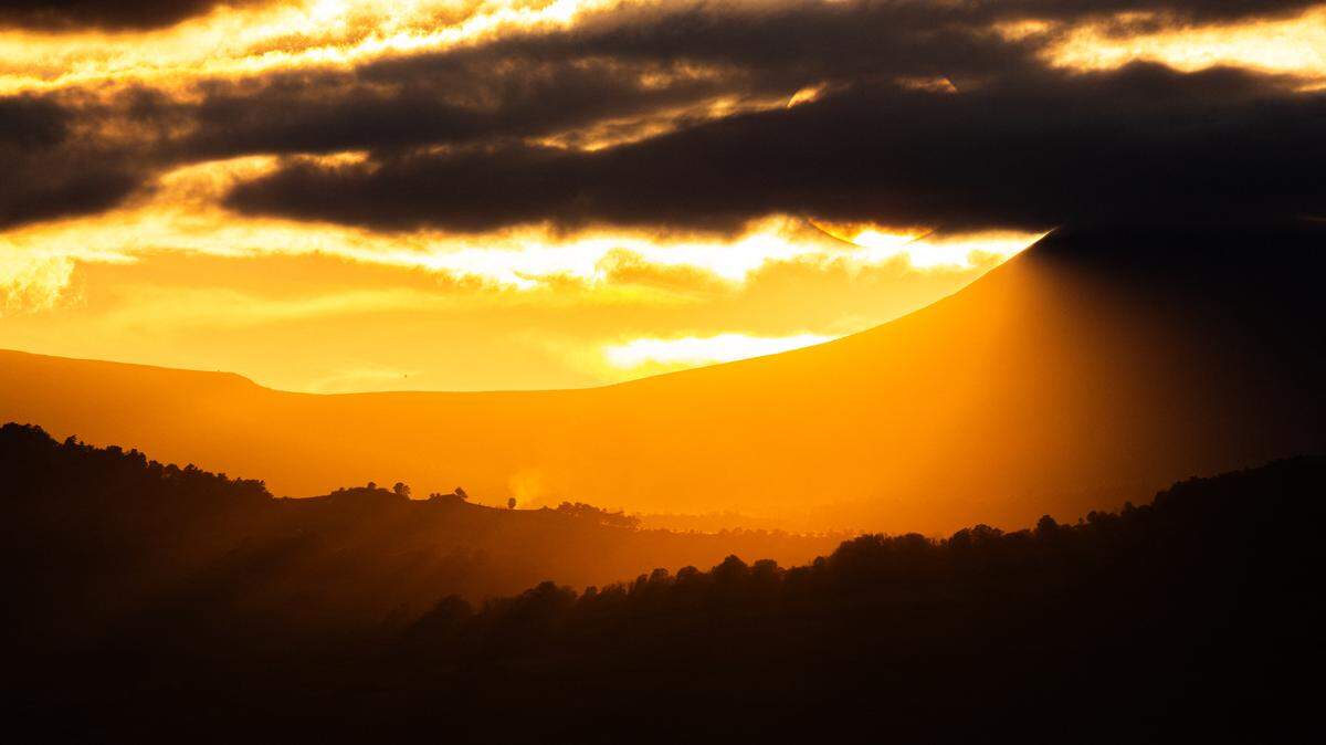 Sunset over the Massif Central from the town of Vic-le-Comte in the Auvergne-Rhone-Alpes region, France, on October 13, 2024.
