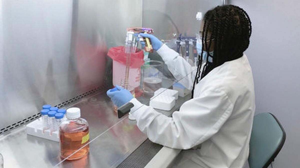 In this undated image from video provided by Regeneron Pharmaceuticals, a scientist works in the company’s Infectious Disease Lab in New York State.