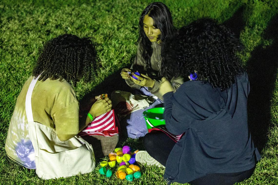 Jessica Fung, 16, Kaylee Aleu, 16, and Genesis Pinales, 16, look over their easter eggs from a helicopter egg drop after a CF Students worship service at Christ Fellowship Church in Palmetto Bay, Florida, on Friday, April 8, 2022.