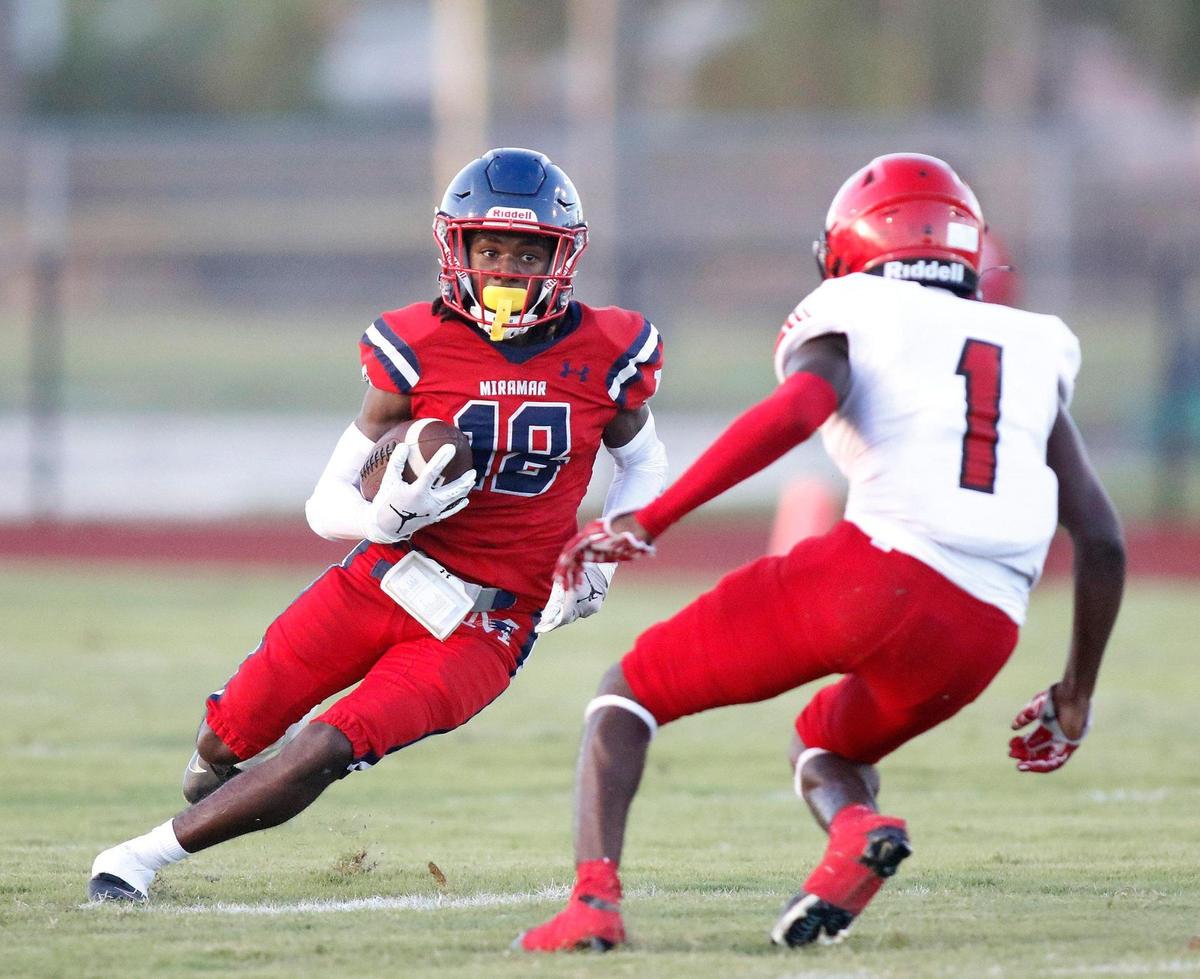 Miramar’s wide receiver Chadman Greaves (18) tries to get around Edison’s defensive back Elgrin Terma (1) during football game on Friday, August 19, 2022 at Miramar High School in Miramar. Andrew Uloza / for The Miami Herald
